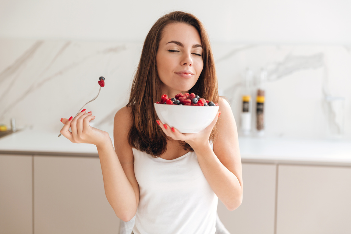 Woman Enjoys Eating Fresh Berries